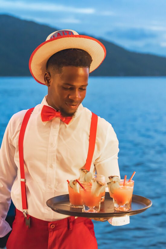 A waiter serving cocktails at Marquis Paradise